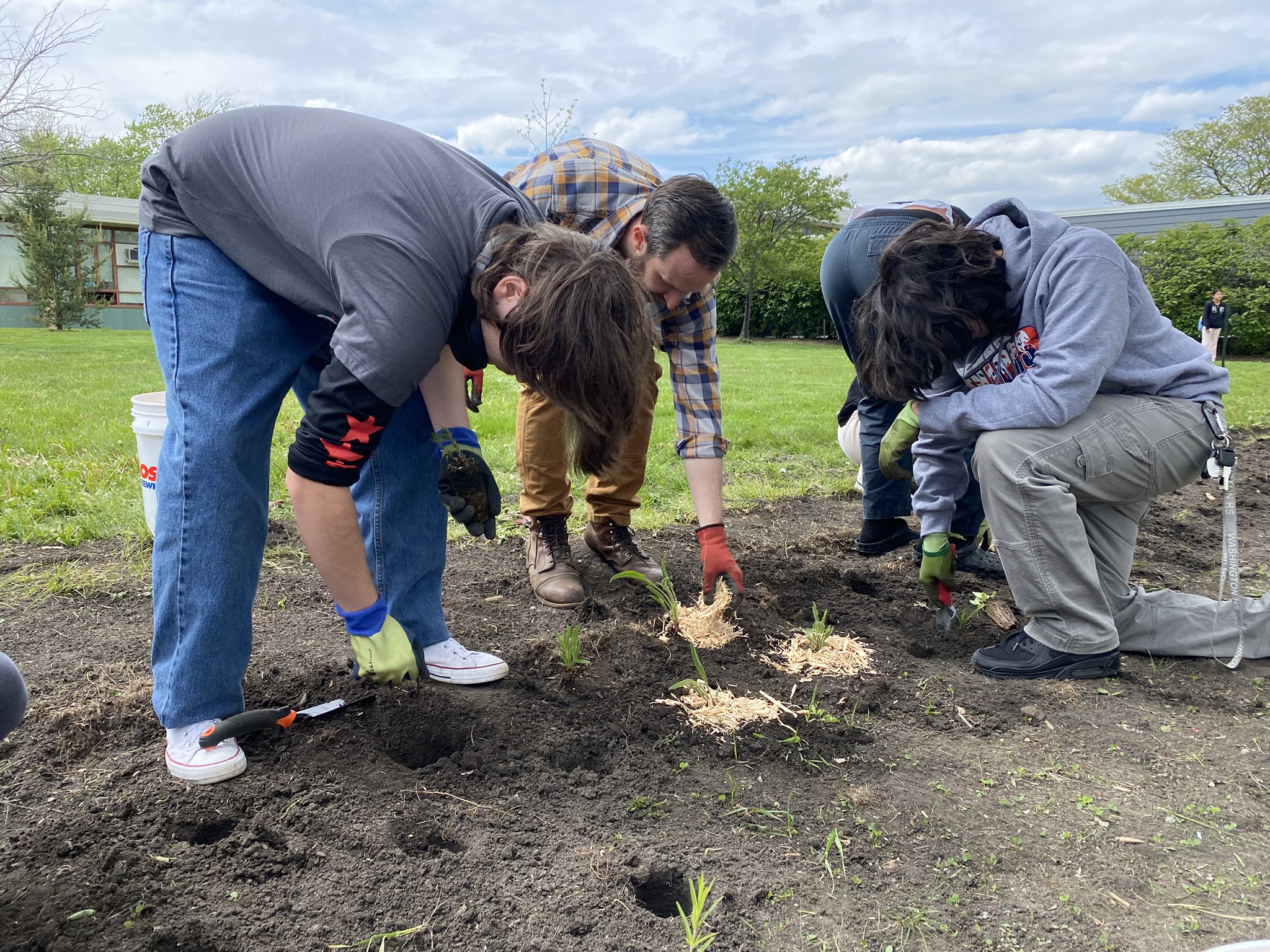Students and their teacher planting natives on a plot at George Washington High School in Chicago.